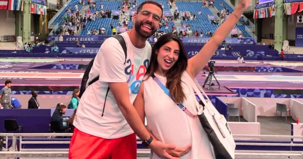 Fencing Olympian competes while carrying a little Olympian